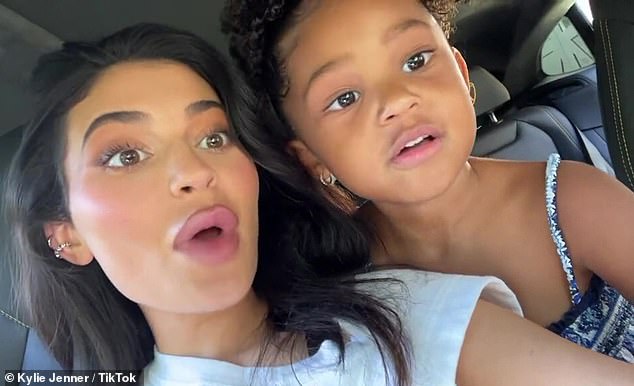 Kylie Jenner cuddles up to Stormi, four, as they mime along to Mamacita