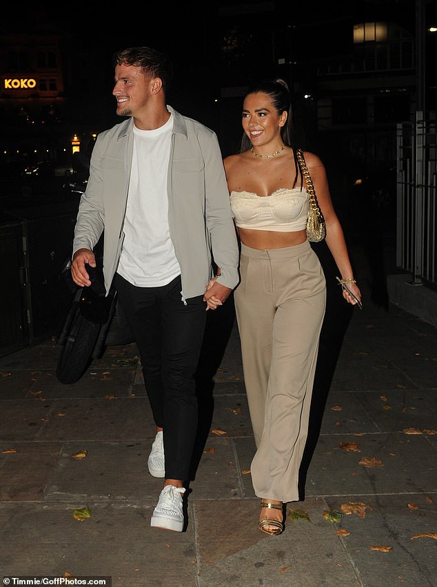 Love Island’s Gemma Owen flashes her abs in a cream crop top alongside her beau Luca Bish