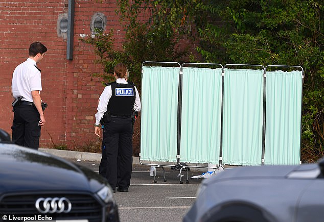 Emergency services have descended en masse to a Liverpool car park where a man is believe to have stabbed himself in the throat