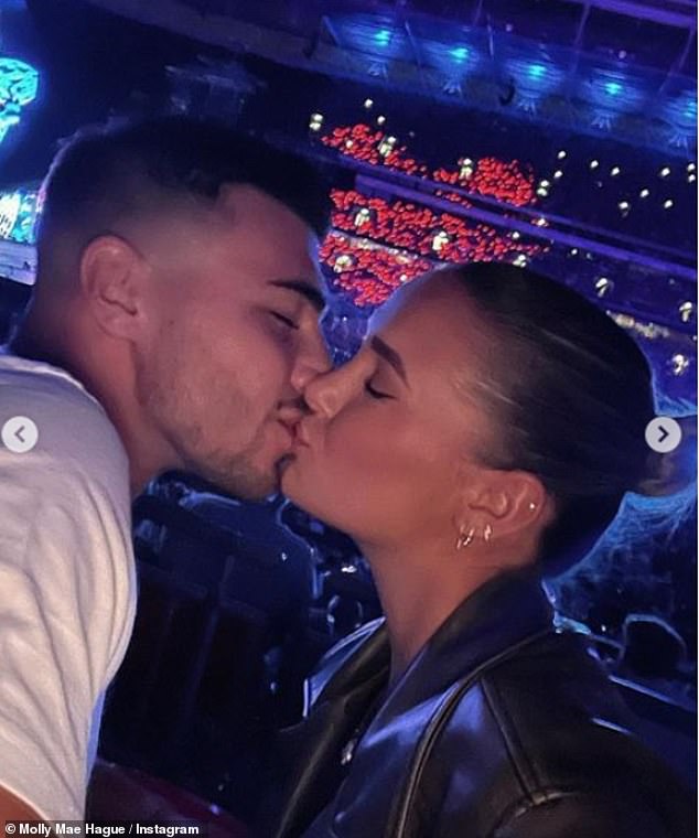 Molly-Mae Hague packs on the PDA with boyfriend Tommy Fury as they watch Coldplay at Wembley Stadium