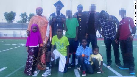 A Jeylani family photo: Top row: Mom, Madina, older brother, Abdikadir, dad, Abdi, older brother, Faisal. Bottom row: younger sister, Famay, older brother, Ali, older brother Abdullahi and Issa. CNN has blurred the faces of other family and friends present for privacy.