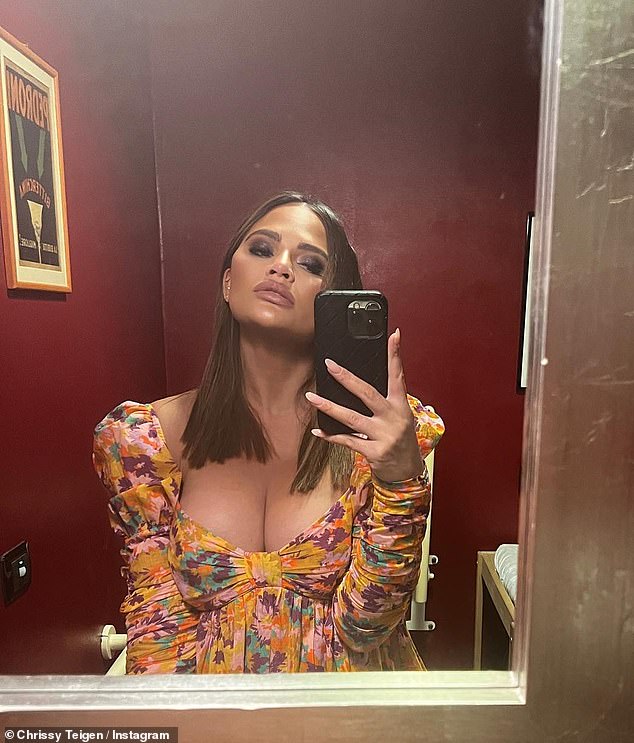 Pregnant Chrissy Teigen looks sensational in a busty floral dress