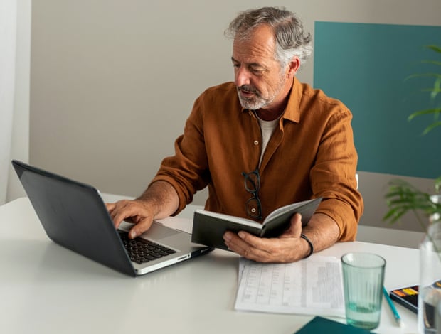 Mature man working using the laptop on the desk