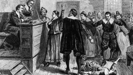 In this illustration, a young woman accused of witchcraft in Salem, Massachusetts, tries to defend herself in front of Puritan ministers.