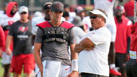 Brady talks with coach Clyde Christensen.