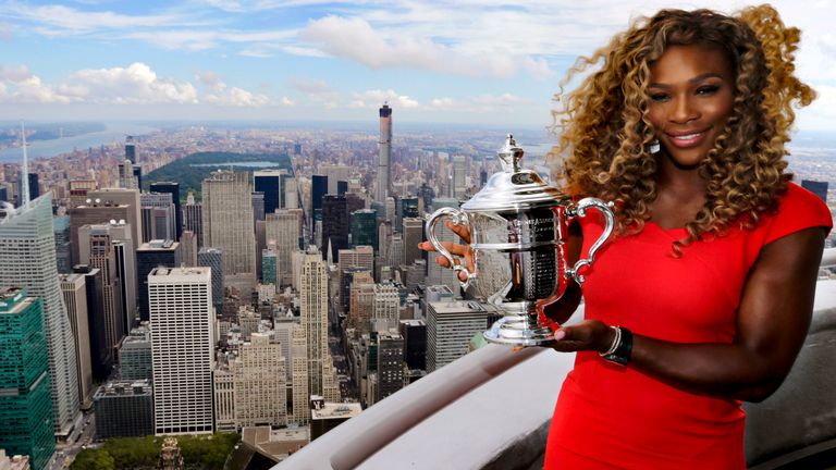 Serena Williams holds the U.S. Open tennis women&#39;s singles championship trophy during a visit to the 103rd floor of the Empire State Building, Monday, Sept. 8, 2014, in New York. 