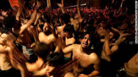 Iraqi Shiite Muslims take part in a ritual of mourning in Sadr City in eastern Baghdad late on August 7 to mark Ashura, a 10-day period commemorating the killing of the Prophet Mohammad&#39;s grandson Imam Hussein in the Battle of Karbala in 680 AD.