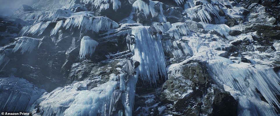 Peak: 'I wish I could be one of them,' Galadriel says as she scales the icy peak, with others seen scaling behind her