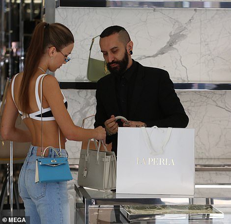 Having a feel: Maria took a closer look inside the mini tote as she held onto it