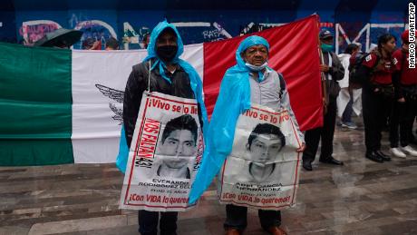 Family members and friends march seeking justice for the missing 43 Ayotzinapa students in Mexico City, Friday, Aug. 26, 2022. Six of the 43 college students &quot;disappeared&quot; in 2014 were allegedly kept alive in a warehouse for days then turned over to the local army commander who ordered them killed, the Mexican government official leading a Truth Commission said Friday.