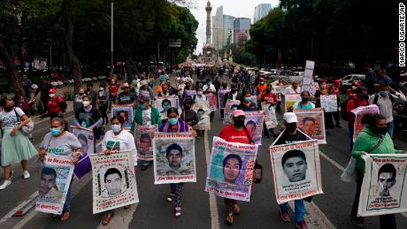 Family members and friends march seeking justice for the missing 43 Ayotzinapa students in Mexico City, Friday, Aug. 26, 2022. Six of the 43 college students &quot;disappeared&quot; in 2014 were allegedly kept alive in a warehouse for days then turned over to the local army commander who ordered them killed, the Mexican government official leading a Truth Commission said Friday.