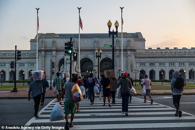 Immigrants walk towards Union Station after arriving in Washington, DC last week after being bussed across the country from Texas, at the order of Texas Governor Greg Abbott