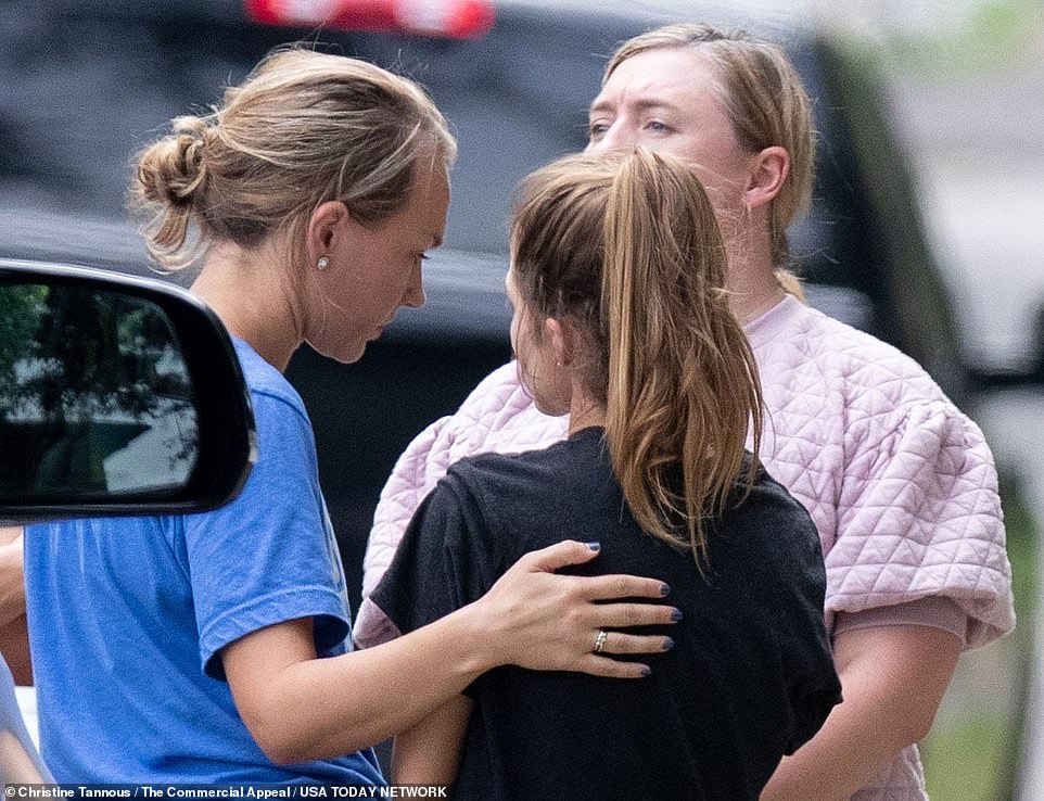 People gather outside the home of Eliza Fletcher on Friday. Police say Fletcher was jogging near the University of Memphis when she was forced into a dark-colored SUV