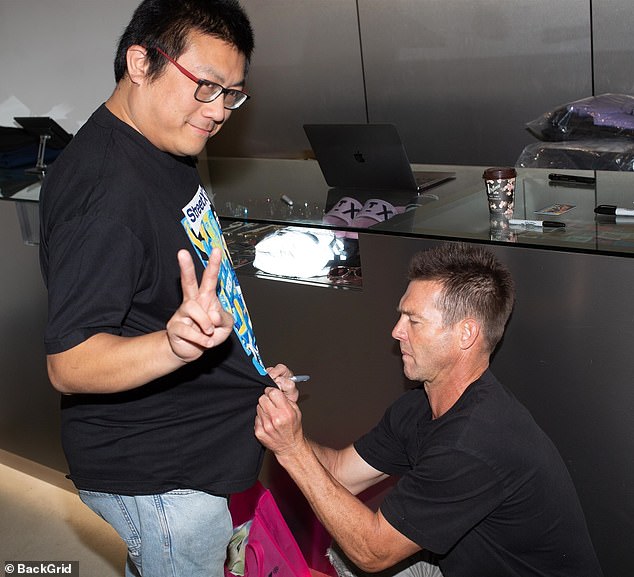 One fan appeared thrilled as Cousins kneeled down and signed a T-shirt from the Prince of Perth collection