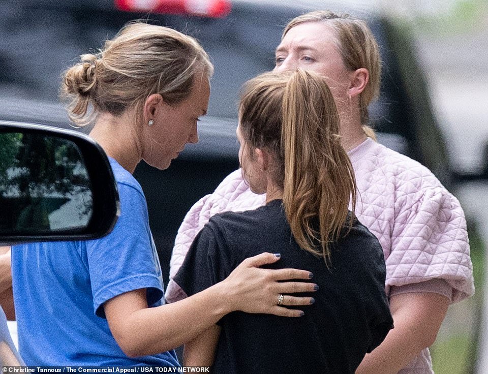 People gather outside the home of Eliza Fletcher on Friday. Police say Fletcher was jogging near the University of Memphis when she was forced into a dark-colored SUV