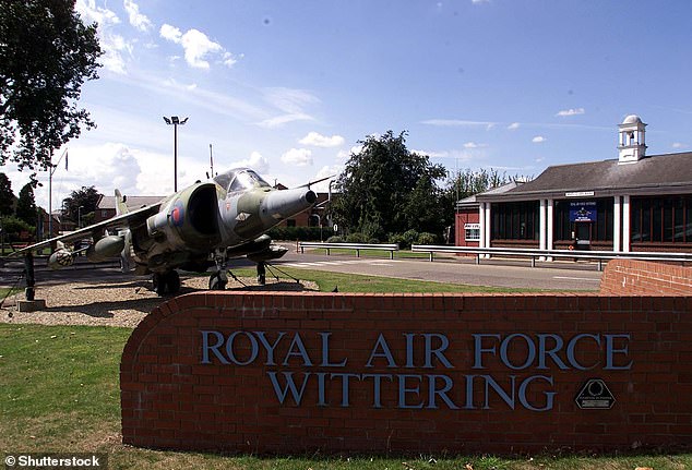 The pair were found inside the blue Ford Focus that was recovered from a pond near to the boundary with RAF Wittering (above), Cambridgeshire, on Saturday evening