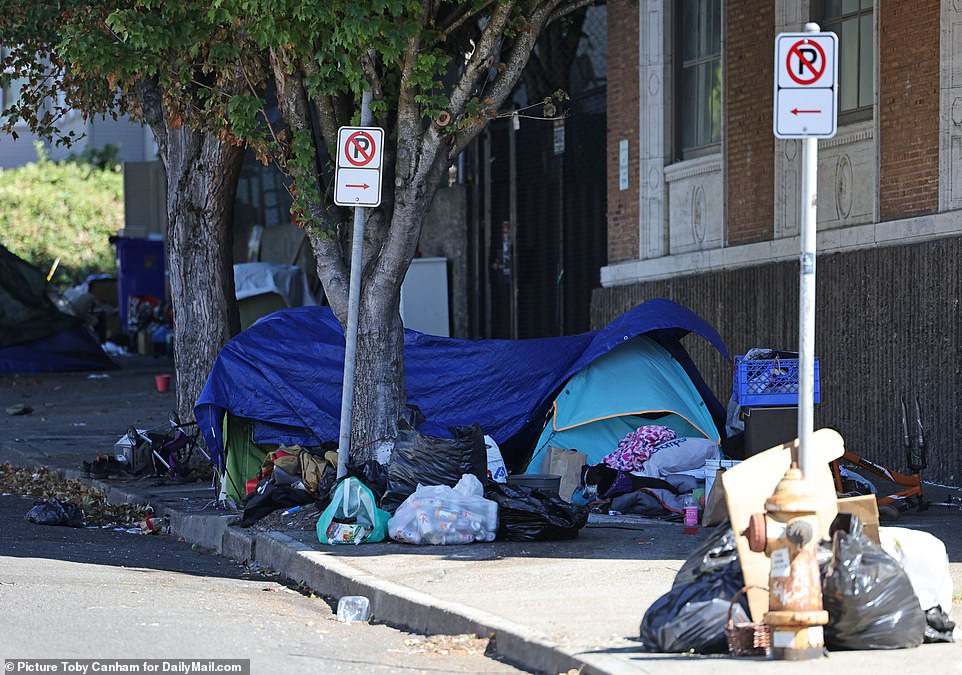 Tents crowd the sidewalk that is littered with trash from homeless communities setting up camp in areas spread from downtown Portland now out through the suburbs