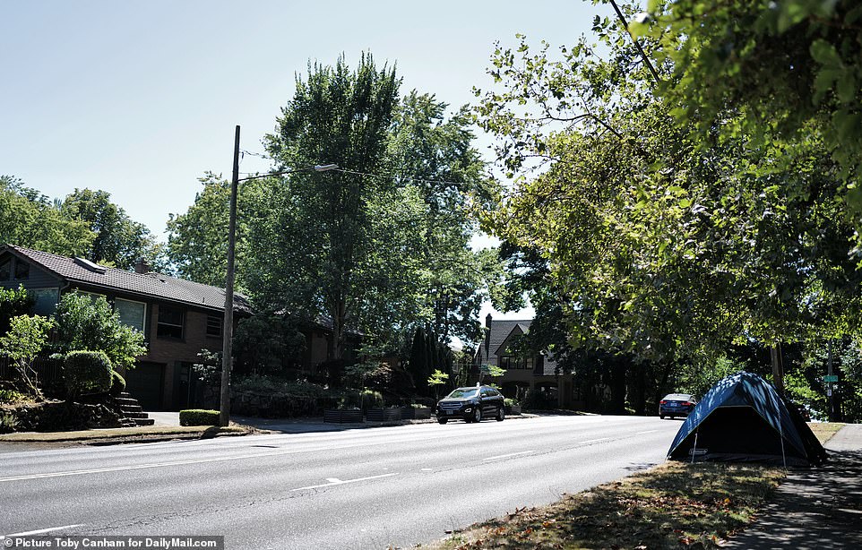 A tent is set up directly across from a home in the quiet suburbs of Portland