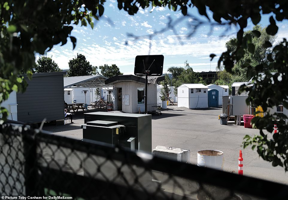 A view of the BIPOC village in the Lloyd neighborhood. Tiny white structures in the lot provide shelter for the homeless