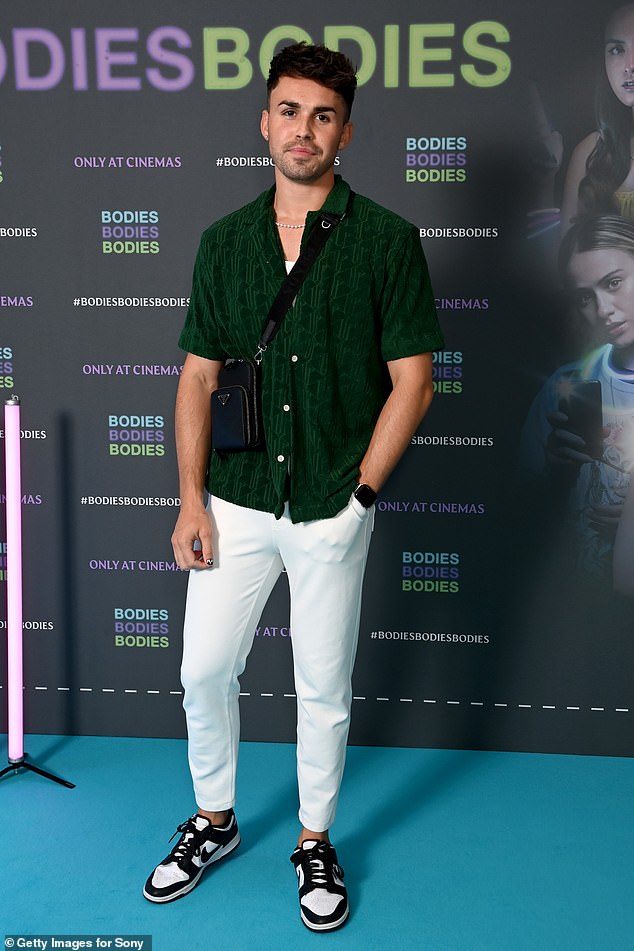 Dapper: Joe cut a dapper figure in a green shirt, crisp white trousers and a pair of black and white Nike trainers