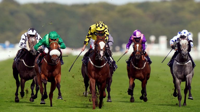 Manaccan (yellow) wins the Scarbrough Stakes at Doncaster under Ryan Moore