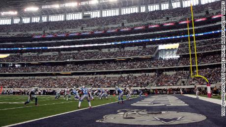 Then Dallas QB Tony Romo leads the Cowboys in the red zone against the Detroit Lions on October 2, 2011 in Arlington, Texas.