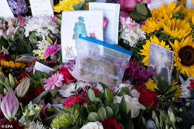 But Royal Parks, which manages the dedicated site for tributes at Green Park, said only unwrapped floral tributes should be left in memory of Her Majesty. Pictured: A marmalade sandwich left for the Queen outside Balmoral Castle