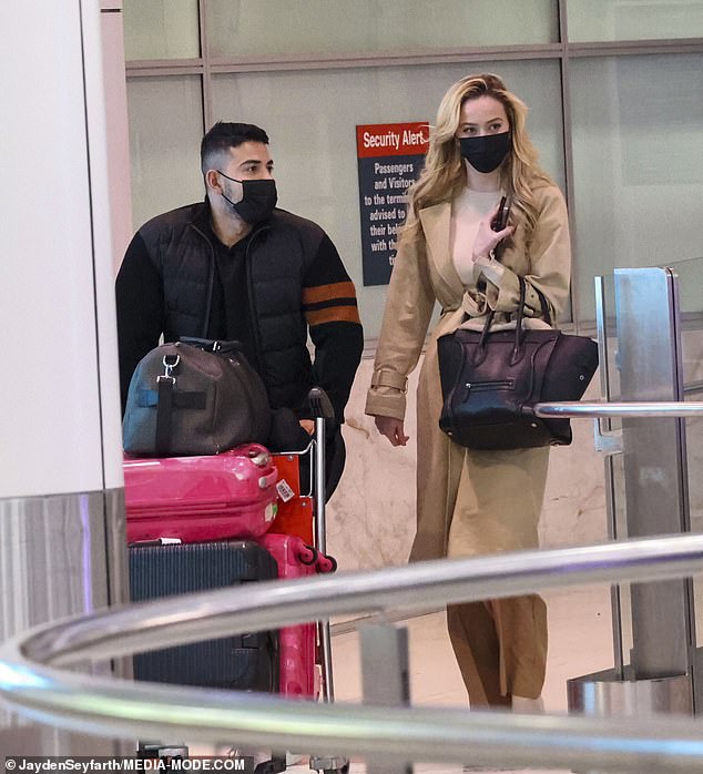 Simone Holtznagel (right) arrives back in Australia last month with boyfriend Jono Castano just as police charged Benjamin Reeves with allegedly stalking her over four months