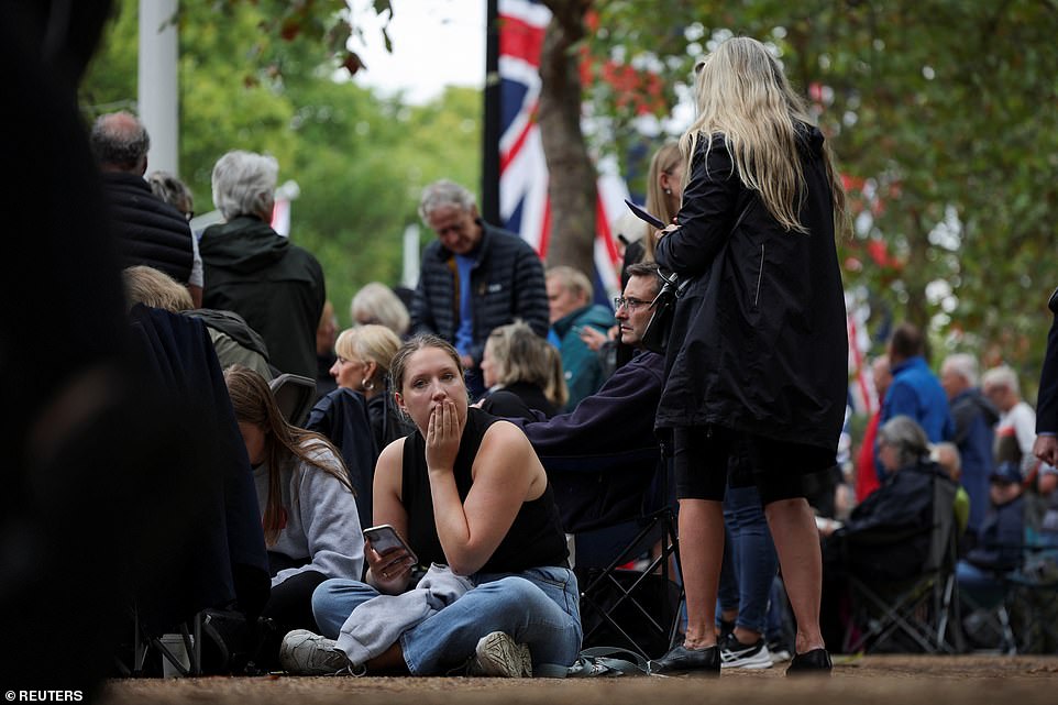 People gather at The Mall on the day the coffin is transported from Buckingham Palace to the Houses of Parliament