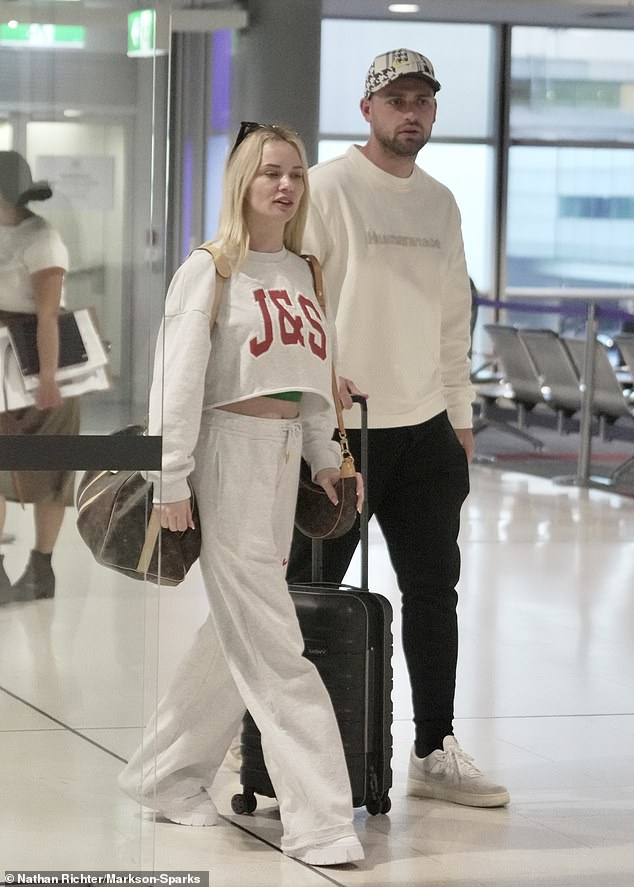 She also wore a white cropped sweater and matching sweatpants