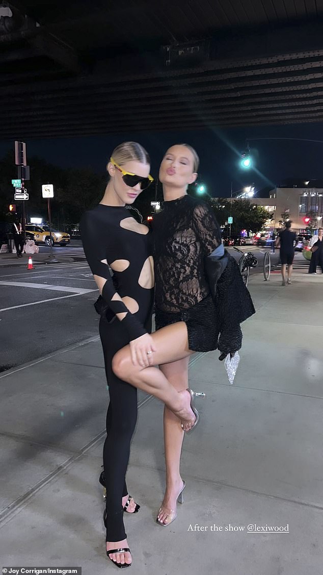 After show antics: Corrigan struck a pose after the Kardashian Boohoo fashion show alongside her fellow model and friend Lexi Wood