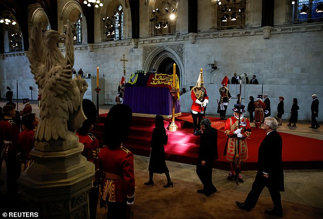 People queue as the coffin of Britain's Queen Elizabeth arrives at Westminster Hall from Buckingham Palace for her lying in state