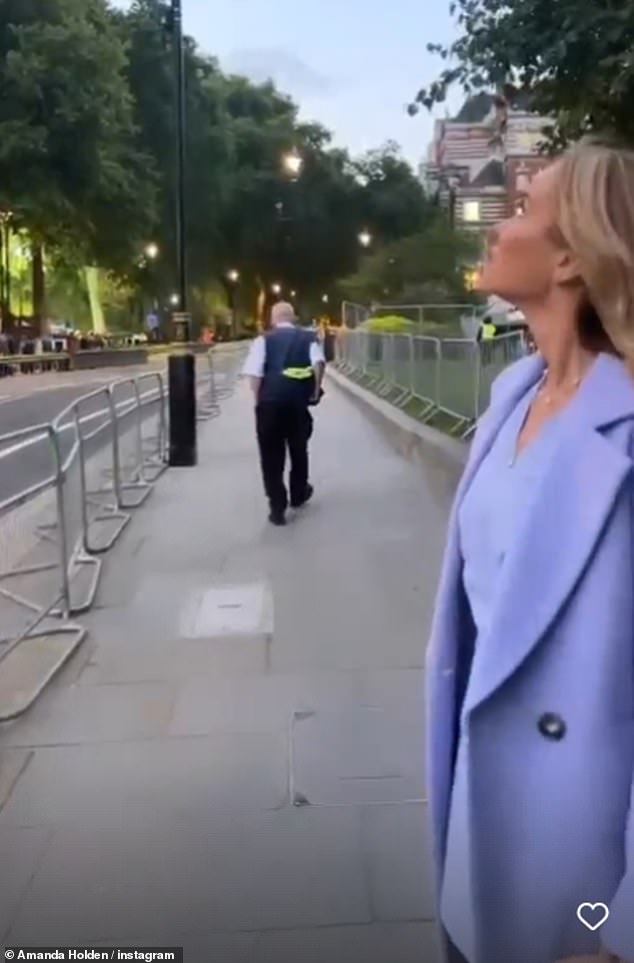 Taking it in: The presenter appeared to be taking it all in as she gazed out at the busy historical landmark