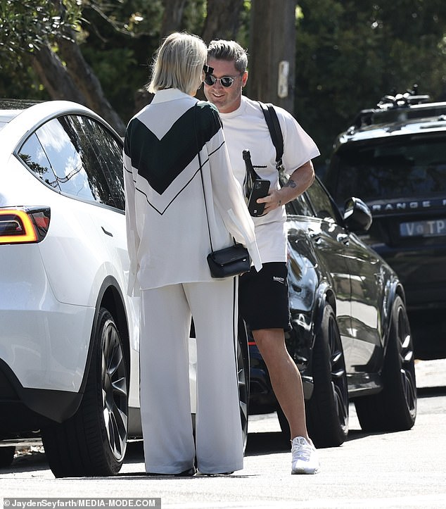 She added a pair of wide-legged white trousers to the look as well as matching black and white heels