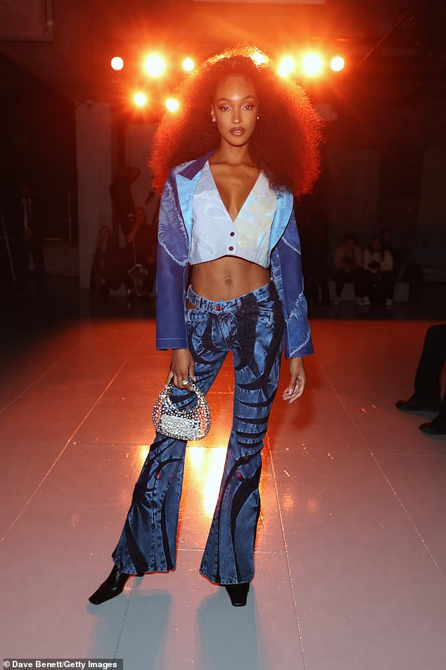 Stylish: Jourdan flashed her abs in a blue cropped blazer, teamed with a pair of quirky jeans and black boots