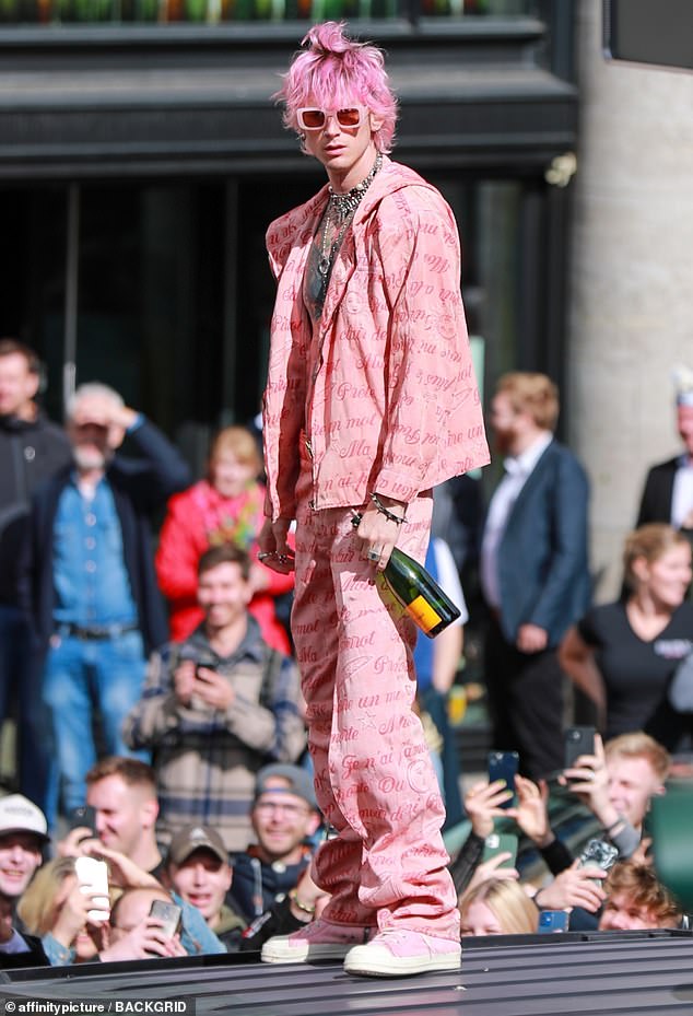 On theme: MGK ¿ born Colson Baker ¿ was dressed in head-to-toe pink, including a jacket and matching pants decorated with cursive writing