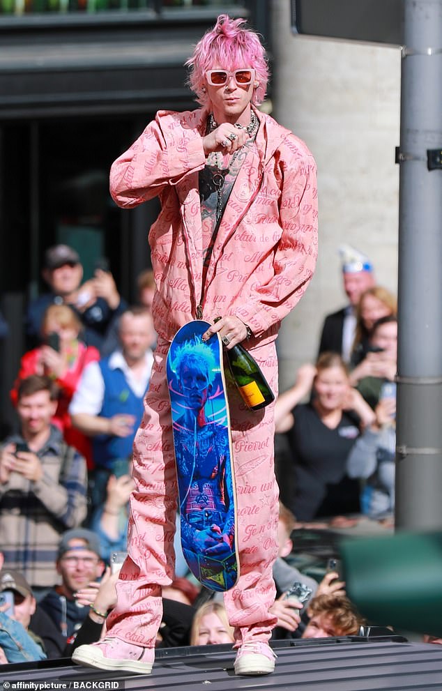 Nailed it: He went shirtless under the suit and rocked pink-and-white sneakers, while his shaggy hair was dyed the same shade