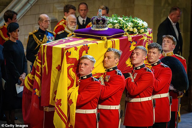 Sombre: It came amid reports the five-mile long queue for people to pay their respects to the Queen has been closed for six hours on Friday, boosting the wait time until 'at least 14 hours'