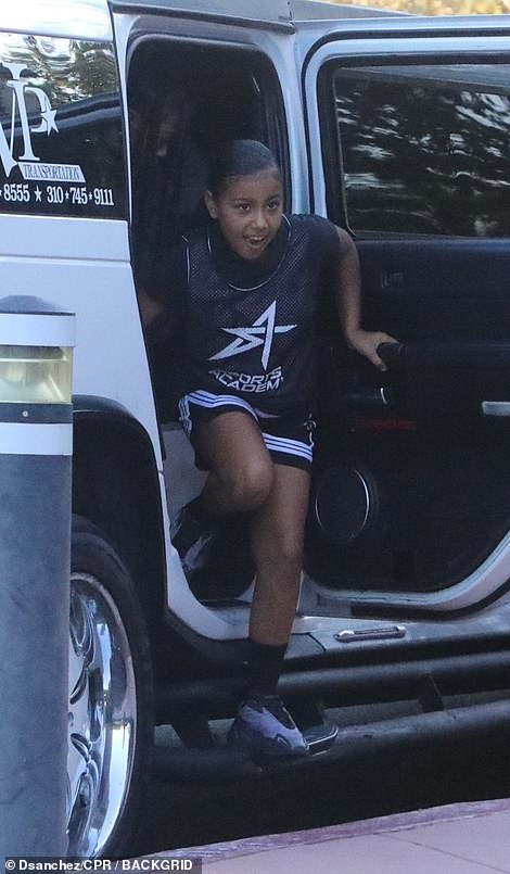 Ready: The young athlete appeared ready for action in a black T-shirt beneath her black team tank top and shorts