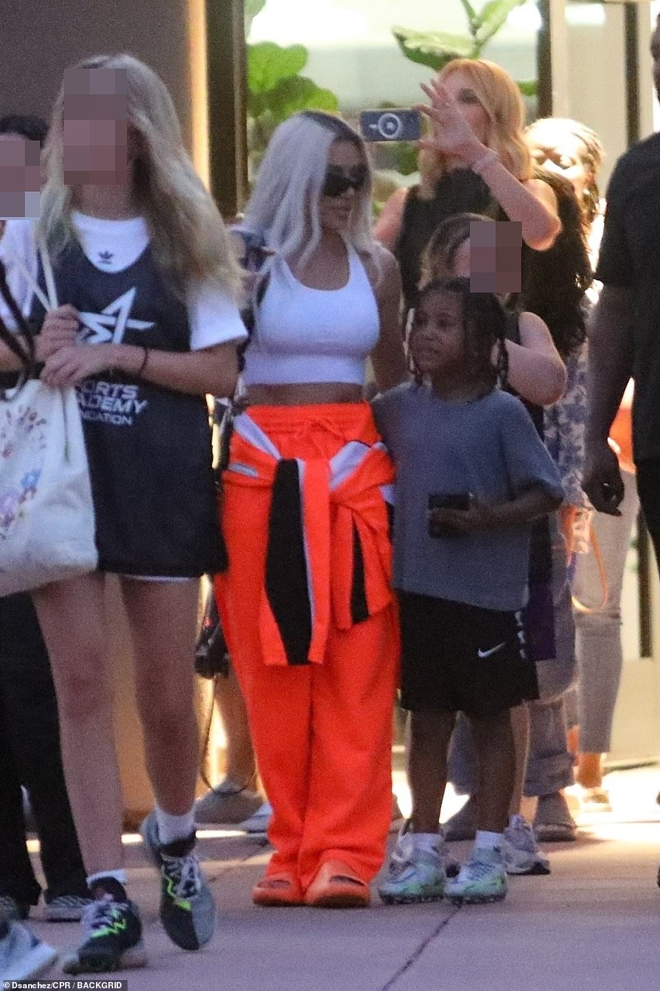 Standing in line: The influencer and her son stood in line with other families waiting for the game to begin