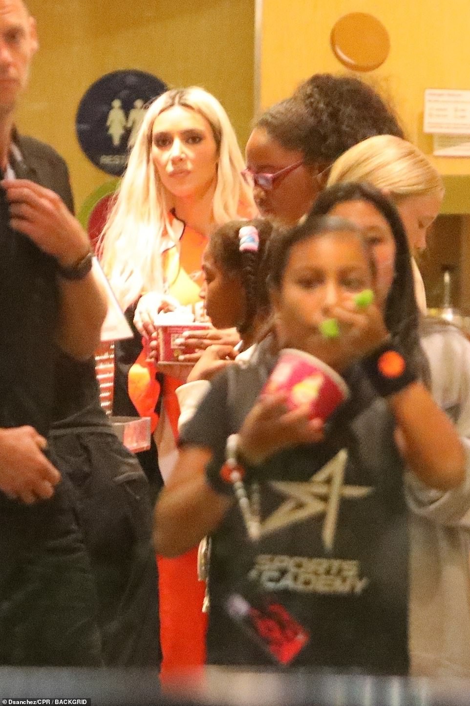 In the crowd:  Kim stood in the crowd with other customers while North enjoyed her snack