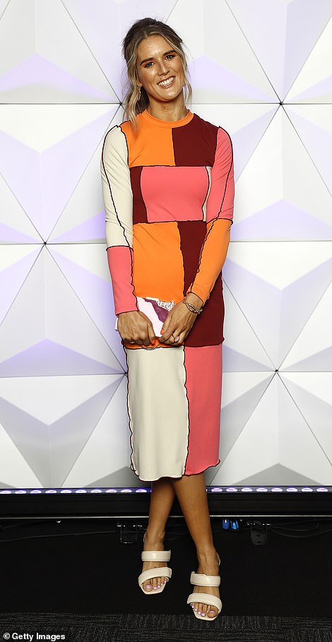 Zoe Heard, the partner of Sydney Swans defender Jake Lloyd, grabbed attention for all the wrong reasons in an abstract midi-dress printed with bright blocks of orange, pink and burgundy