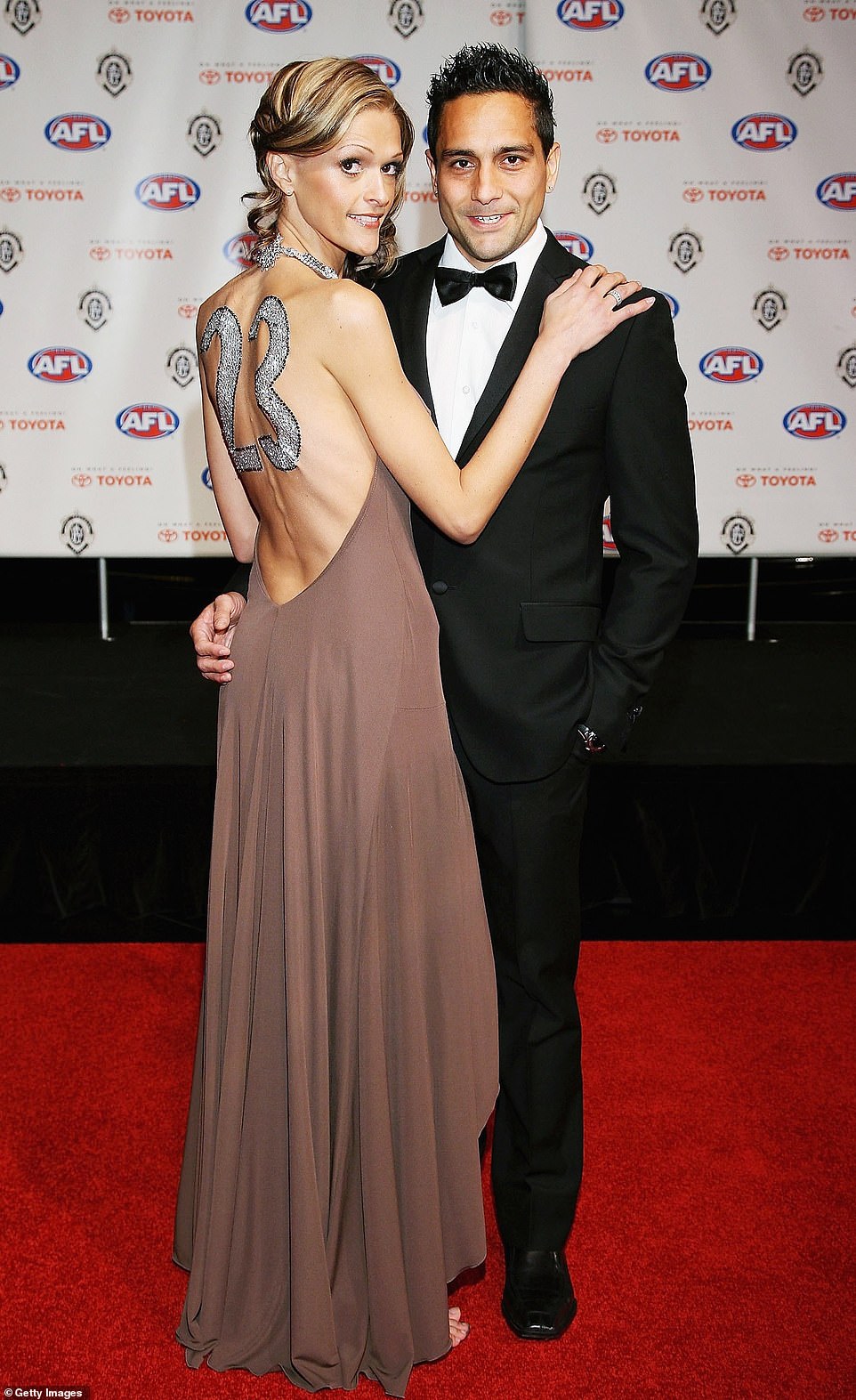 Andrew McLeod of the Adelaide Crows and his wife Rachel McLeod arrive for the 2006 red carpet with an interesting '23' on the back