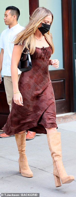 Ravishing in red: Robbie wowed in a floral crimson dress that showed off her toned arms during her night on the town