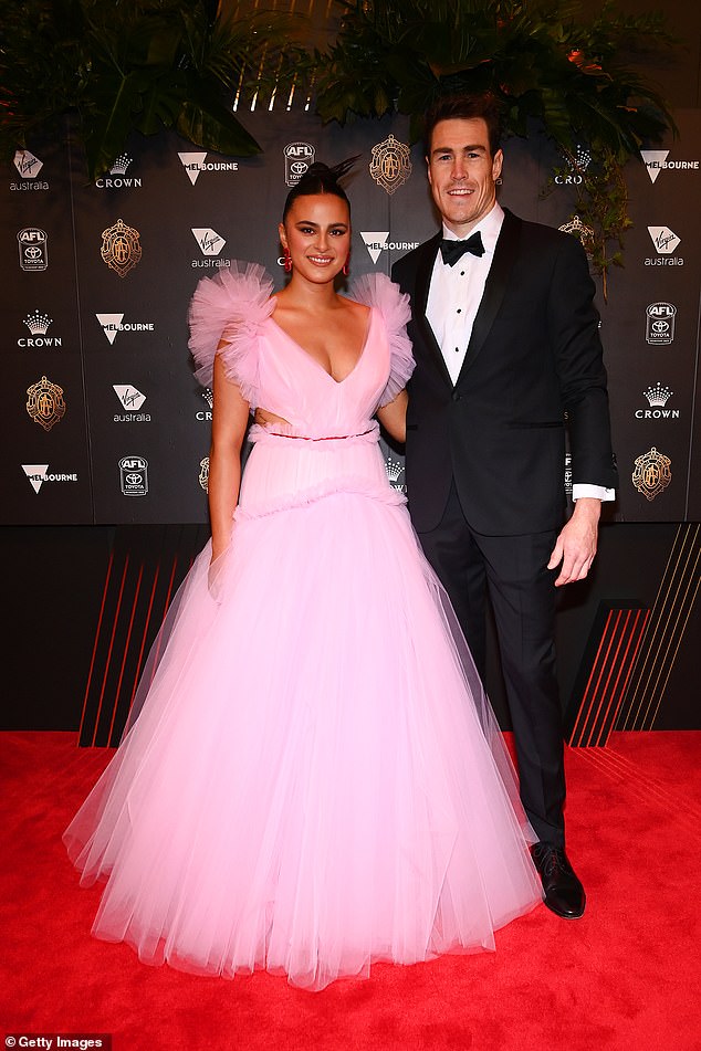 Jeremy meanwhile looked suave in a black suit with a matching bow-tie. The Greater Western Sydney Giants player completed his look with a crisp white shirt and leather boots