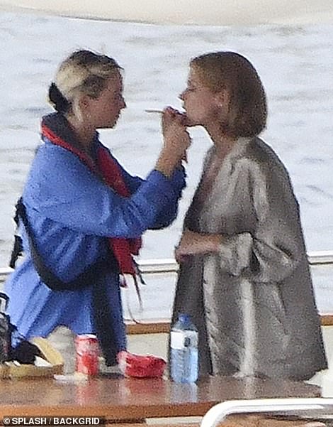 Touch up: A makeup artist was seen applying lipstick