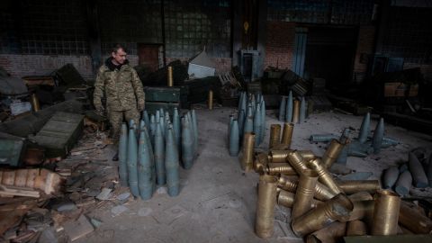 A Ukrainian service member checks Russia artillery shells captured during a counteroffensive operation near the town of Izium on September 14, 2022. 