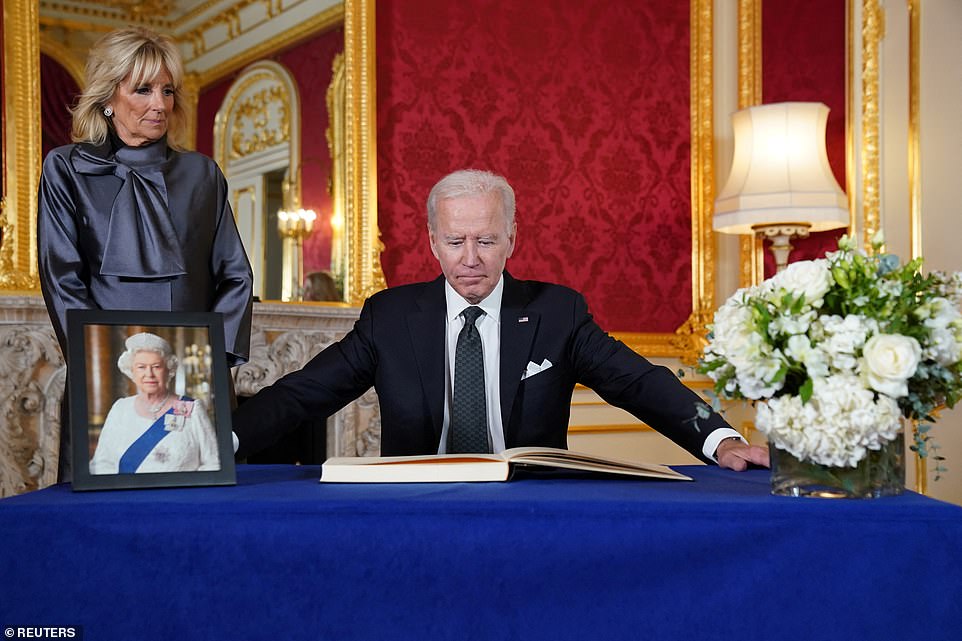 President Joe Biden signs a condolence book for Queen Elizabeth II at Lancaster House in London on Sunday after viewing her coffin as it lay in state in Westminster Hall