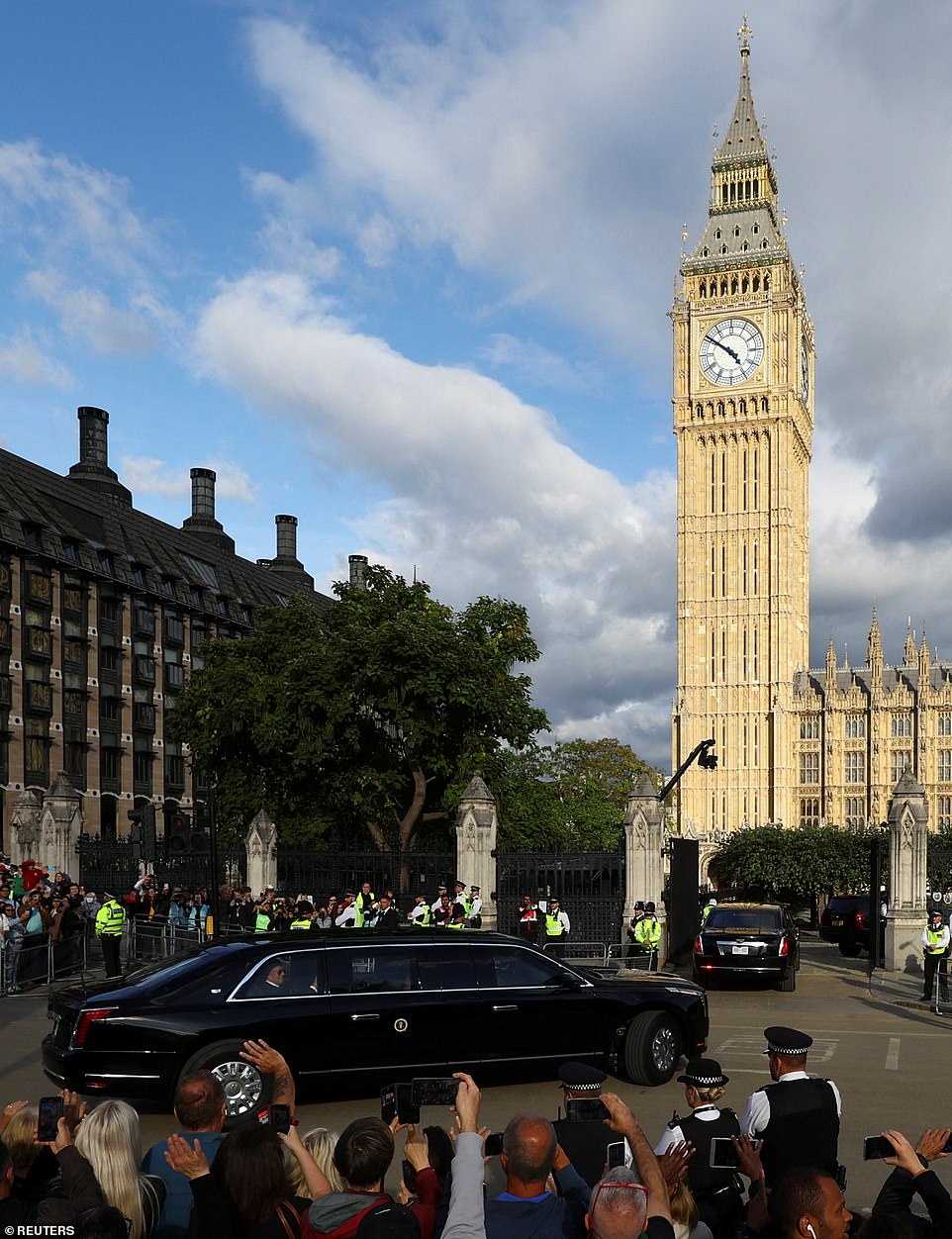 The iconic Big Ben can be seen as President Joe Biden is pictured through the window of his vehicle waving to bystanders while arriving at Westminster Hall on Sunday