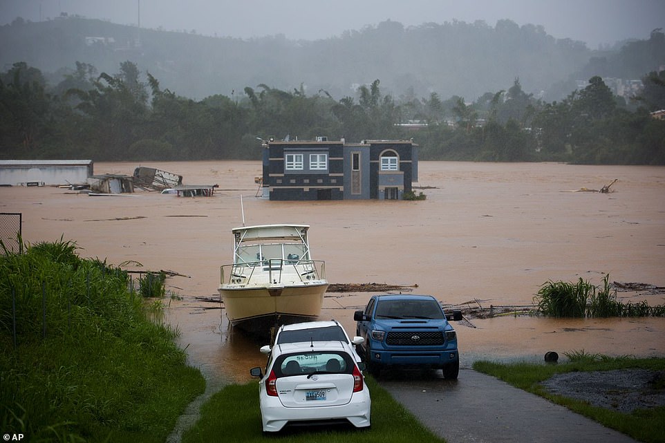 Several people were tripped inside this house which now stands in what looks to be the middle of a raging river